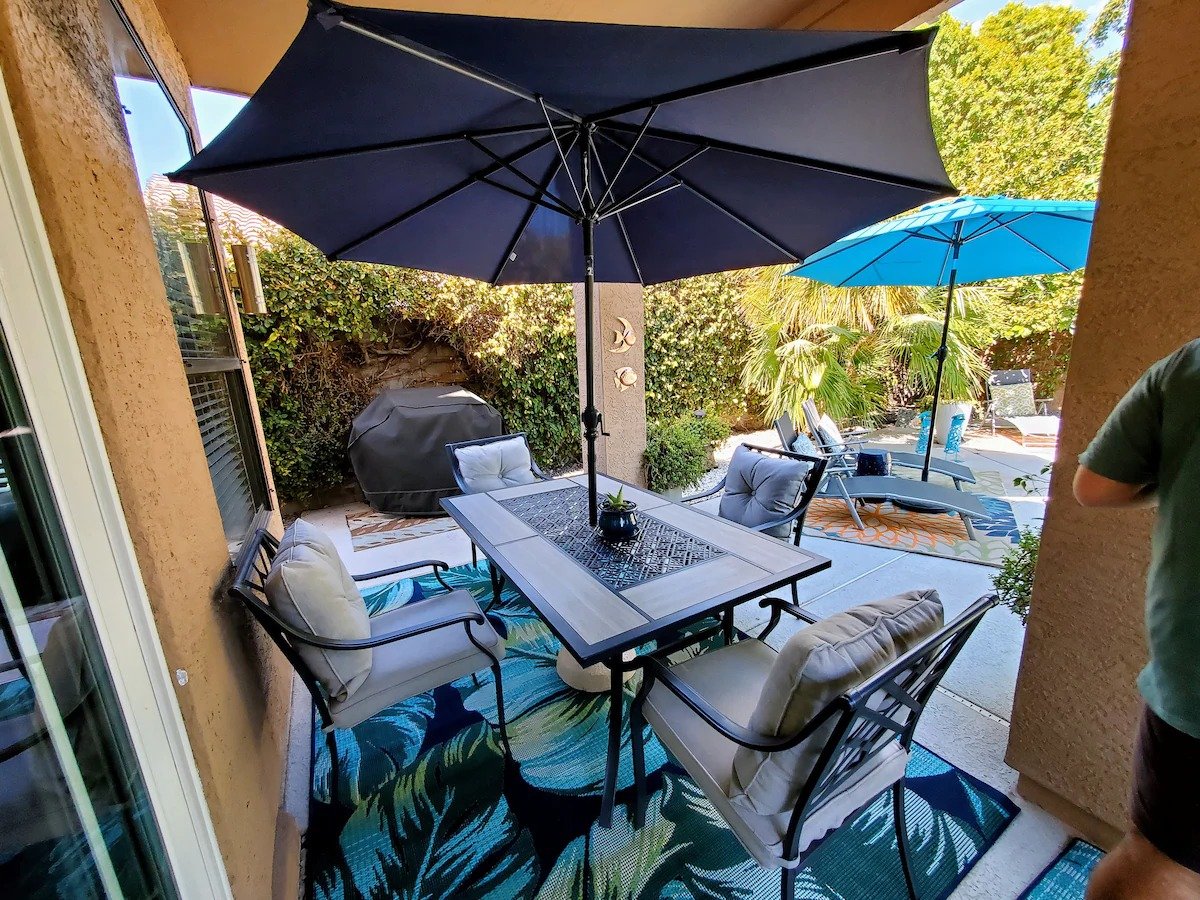 Outdoor fire pit and sun loungers in the landscaped backyard